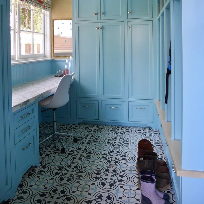 Mission Roseton Cement Tile Pattern in black, white, and blue is the pattern flooring chosen for this beautiful blue mudroom.
