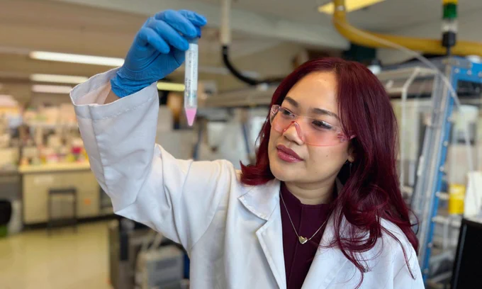 Sue Lyn Yap studying nanoparticles in a test tube at an RMIT lab. 