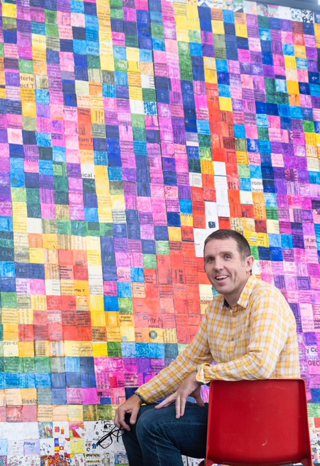 Dr Calum Torrie of LIGO with the gravitational wave detection mosaic made by staff and pupils at Cardonald Primary School