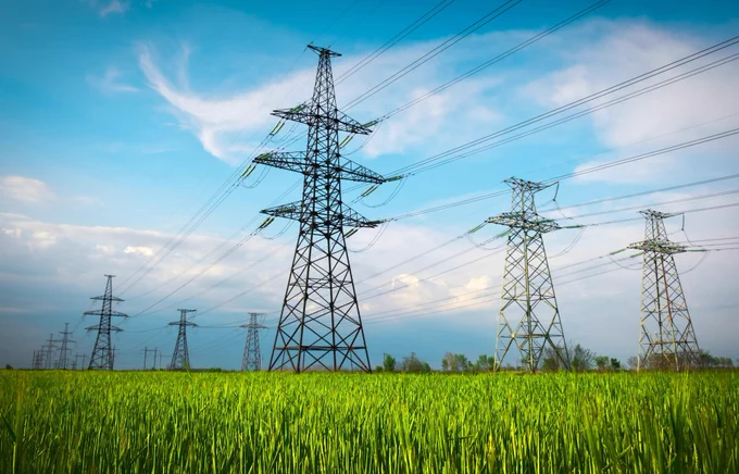 Electricity pylons in a green field