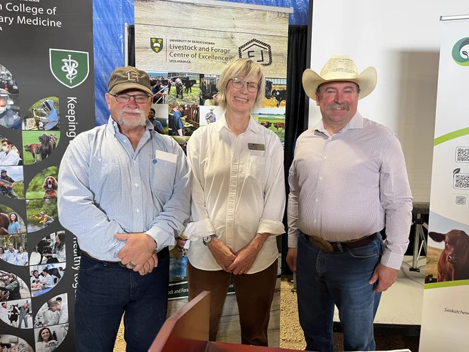 Minister Daryl Harrison standing with Dr. Gillian Muir and Dr. Scott Wright from the University of Saskatchewan's Livestock and Forage Centre of Excellence.
