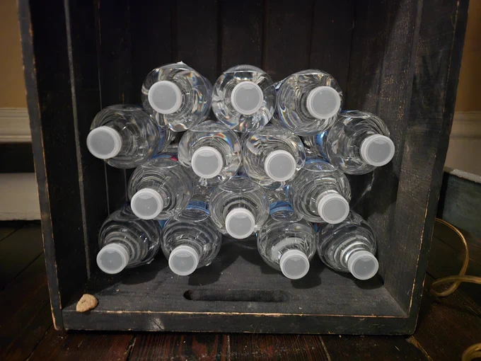 One can see these water bottles in rows as 3, 4, 3, 4.