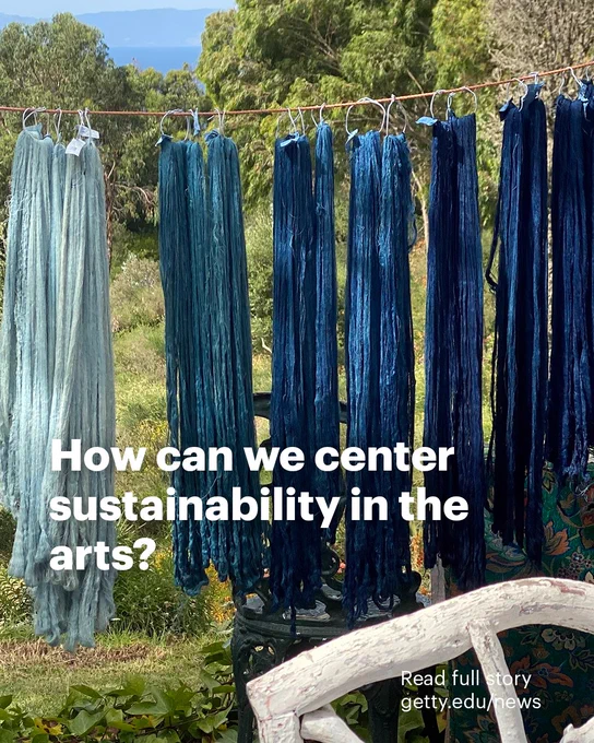 Dyed yarn hangs on a line in various shades of blue. Text reads: "How can we center sustainability in the arts? Read full story getty.edu/news"
