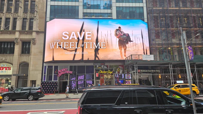 *Large LED billboard in Midtown Manhattan advertising "SAVE THE WHEEL OF TIME"