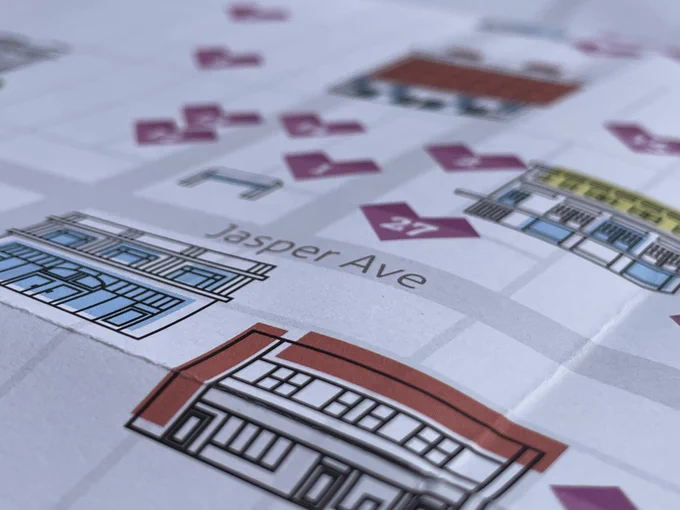 A close-up of the printed map with two buildings on a grid of downtown Edmonton streets, including Jasper Avenue. 