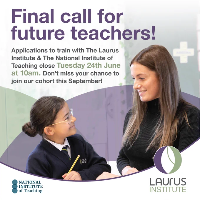 Primary school pupil with a pencil in hand looking up and smiling at a teacher who is smiling back at the pupil
