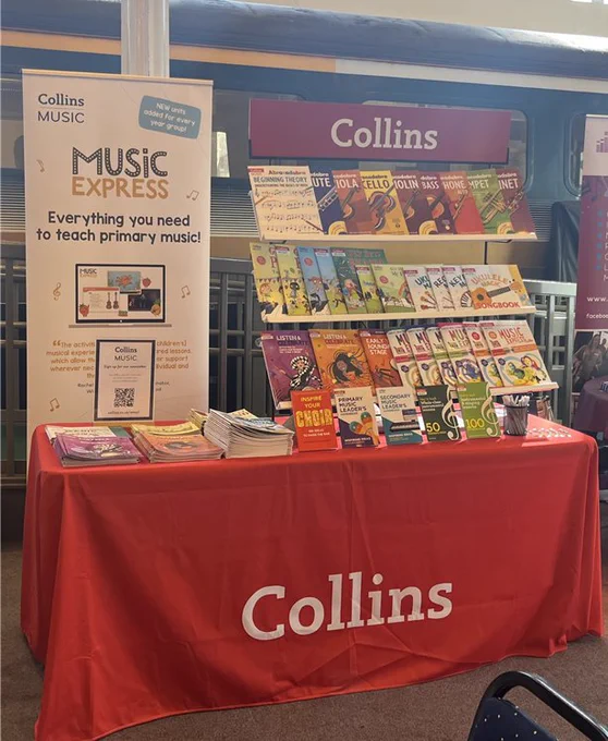 A photo of a table covered in Collins branding with different music books on display. 