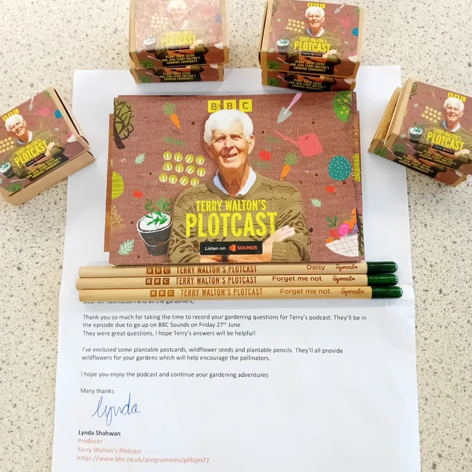 A promotional package for BBC's 'Terry Walton’s Plotcast' podcast, featuring five seed boxes, plant-able postcards, and four branded pencils labelled with wildflower names. A letter from a producer thanks recipients for submitting gardening questions and mentions the episode release date on BBC Sounds as Friday 27th June