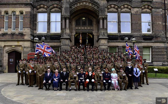 Group shot outside town hall of Duke of Lancaster Regiment and St Helens Borough Council representatives