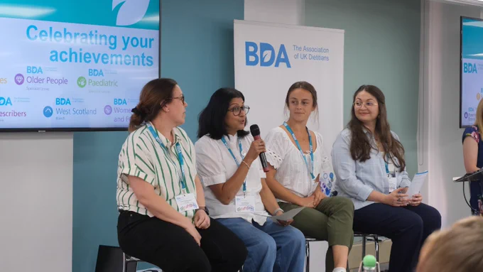 Photo of BDA volunteers talking about their group and branch successes in 2024/25.