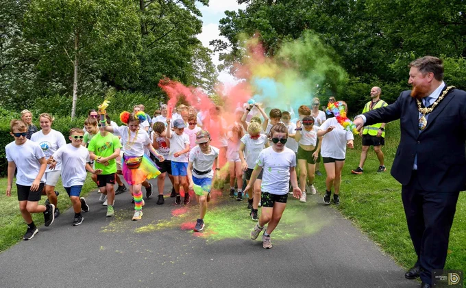 Mayor of St Helens Borough, Cllr Seve Gomez-Aspron pictured starting off the Colour Run race with colour exploding over participants at Victoria Park