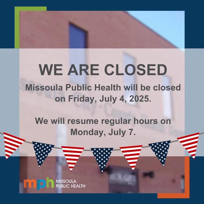 A blurred image of the front of the Missoula Public Health Department building with red, white, and blue flags going across it. Text says, "We are closed. Missoula Public Health will be closed on Friday, July 4, 2025. We will resume regular hours on Monday, July 7."