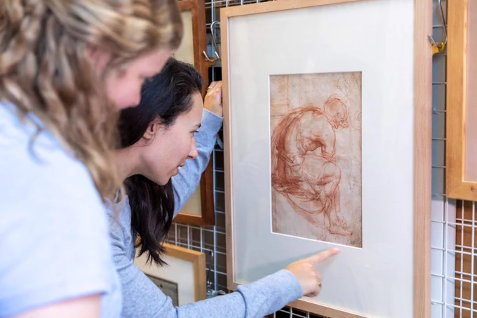 A picture of staff and students examining artworks in the collection and artwork by Peter Paul Rubens, Study for the Head of Marie de' Medici, 1622, black chalk on paper. UAC/10539.