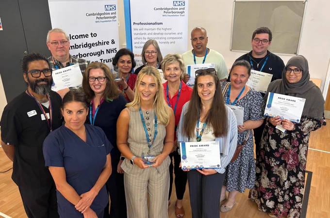 Group of healthcare professionals proudly displaying awards at Cambridge and Peterborough NHS Foundation Trust event.