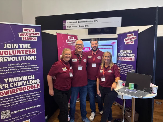 Group photo of Royal Voluntary Service staff at their stand at the gofod3 event at Cardiff City Stadium.