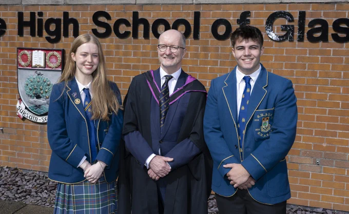 The Rector of The High School of Glasgow, John O'Neill, in-between the 2024-25 School Captains.