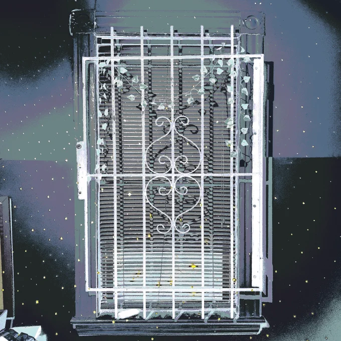 A sankofa gate closed with blinds in front of projected lights and stars.