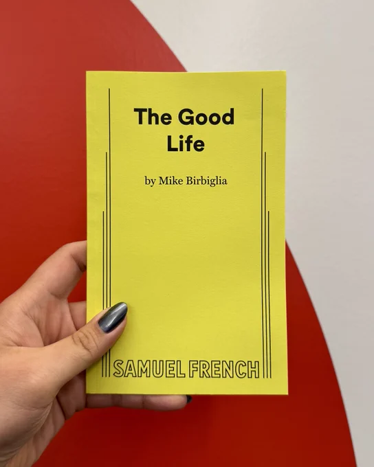 A hand holds Mike Birbiglia's The Good Life playtext.