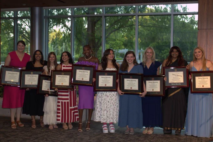Group picture of OB-GYN Class of 2025 graduates holding their framed diplomas. 