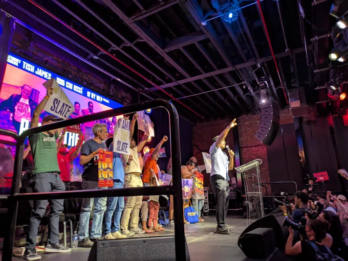 Photo of Chi Ossé speaking at an indoor WFP rally.