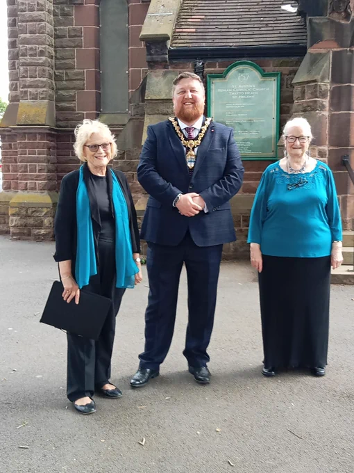 Mayor of St Helens Borough, Cllr Seve Gomez-Aspron, pictured with members of Pilkington Choir outside St Austin's Church