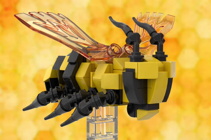 Close-up of prototype LEGO bee showing yellow body with black stripe, black, articulated legs, black antennae and mouth parts and amber wings on a clear plastic LEGO plinth