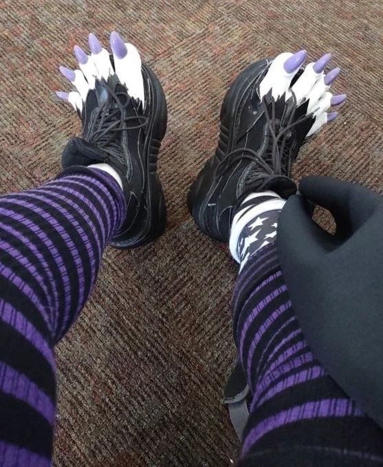 POV: wearing black Demonia 4 inch platform shoes with the fronts torn open and white clown toes popping out of the front.  The toes have shiny purple claws :o)