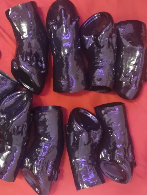 Black latex hooves meant to be worn over hands and shines with Vivishine, which is a silicone oil-based lubricant.