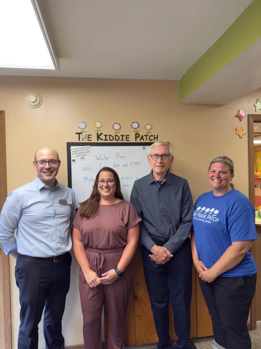 Gov. Evers poses for a group photo with Sarah, her staff, and DCF Secretary Pertl