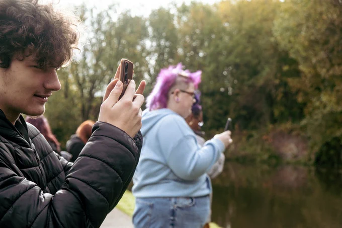 Young people using phones to take photos