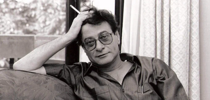 Imagem mostra o poeta palestino Mahmoud Darwich de camisa, em um sofá, com um cigarro na mão.