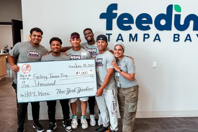 FCL Yankees present a check to Feeding Tampa Bay for HOPE Week.