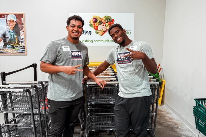 Two FCL Yankee players at the Feeding Tampa Bay market.
