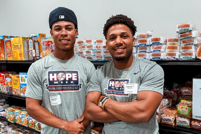 Two FCL Yankee players at the Feeding Tampa Bay market.