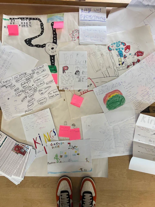 A collection of papers with written stories splayed on the floor