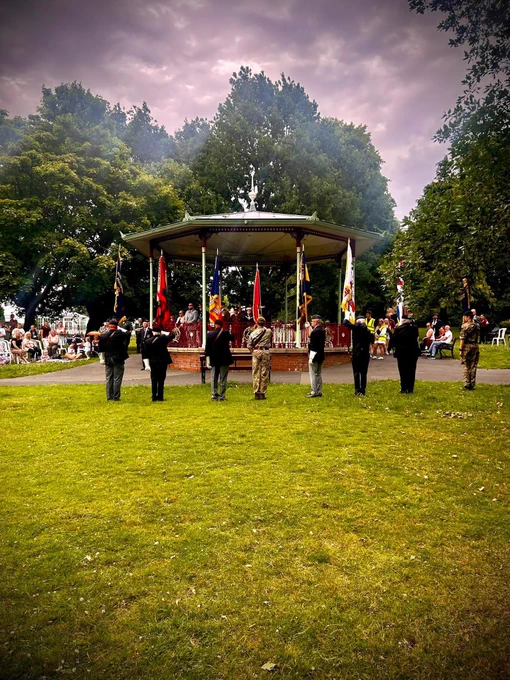 Band stand in Victoria Park surrounded by Military Personnel with flags for Armed Forces Day event