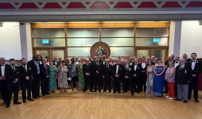 Group photo of all attendees of Armed Forces Day dinner at St Helens Town Hall
