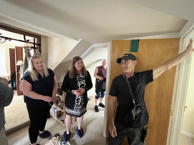Secretary Blumenfeld and Assistant Deputy Secretary Maas stand inside the Project Home house with Project Home staff members and are given a tour.