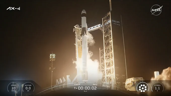 A still frame of Axiom Mission 4 as it lifts off from NASA's Kennedy Space Center. The Falcon 9 rocket is brightly lit by the launch flames beneath it; various graphics around the edge of the frame feature the launch countdown clock, velocity of the rocket, and other key data. Credit: NASA 