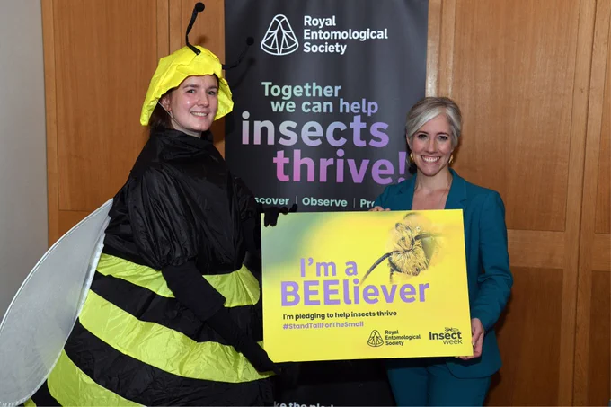 Fran Sconce, Senior Learning & Outreach Officer, the Royal Entomological Society with Daisy Cooper MP (Liberal Democrat, St Albans) holding the Insect Week Pledge