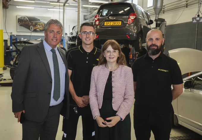 The Minister is pictured Workforce General Manager Paul Boyle, and former Workforce apprentices Michael Kinsella and John Webb, who both now work for the AA.