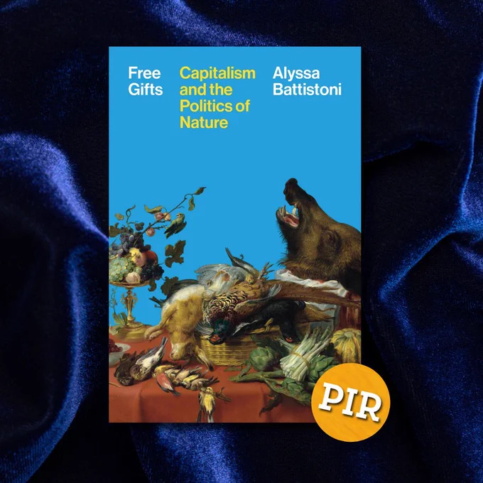 The book cover of Free Gifts: Capitalism and the Politics of Nature by Alyssa Battistoni is set against a dark blue velvet fabric. The cover itself is bright blue with a classical still life painting at the bottom, featuring fruits, vegetables, and animal carcasses arranged on a red tablecloth. The title and author’s name are printed in bold white and yellow text at the top. A circular orange PIR logo overlaps the bottom-right corner.
