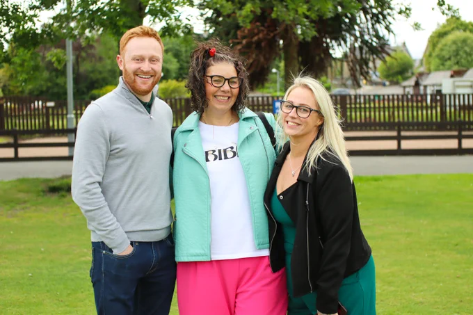 Ashley, supported by SAMH, stands with SAMH colleagues Kevin and Vicki
