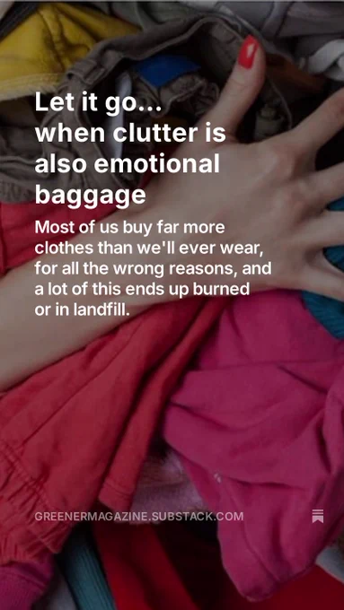 a woman's hand clutching a pile of clothes she no longer wants or needs