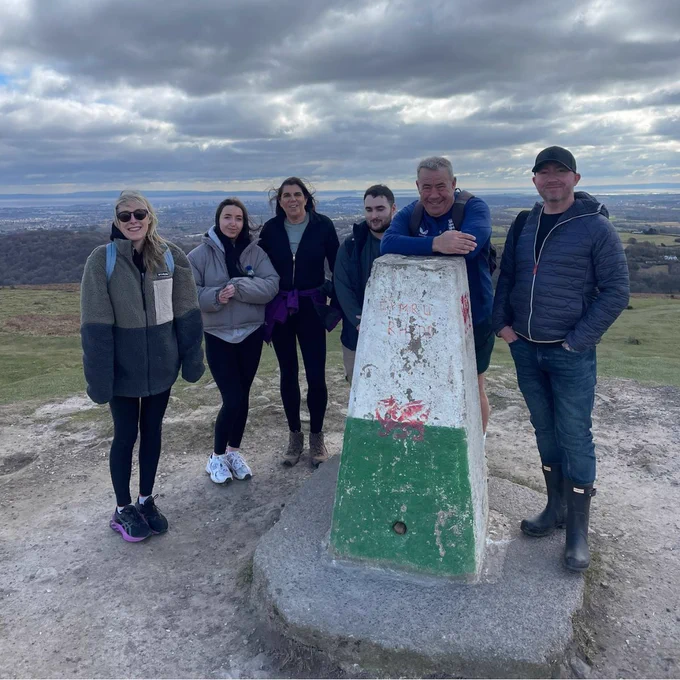 A few Effective team members stood smiling on top of Garth Hill.