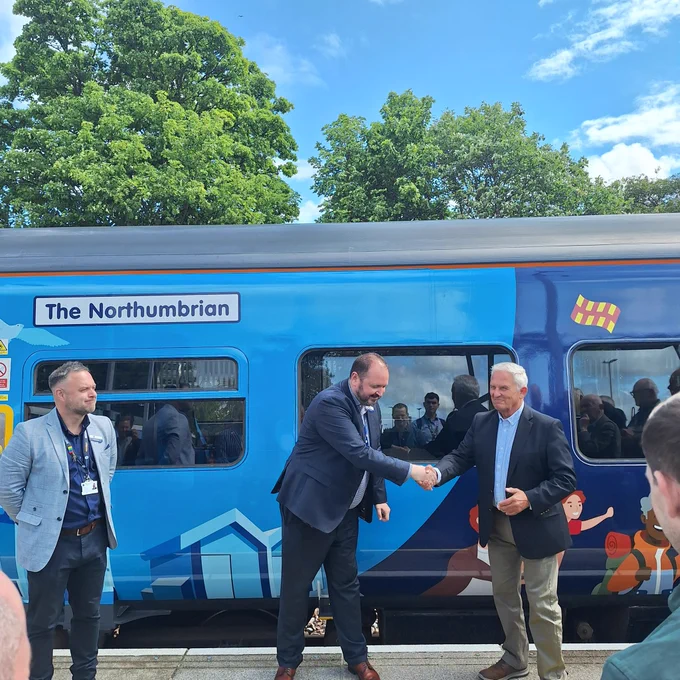 Staff members and local council with the train.