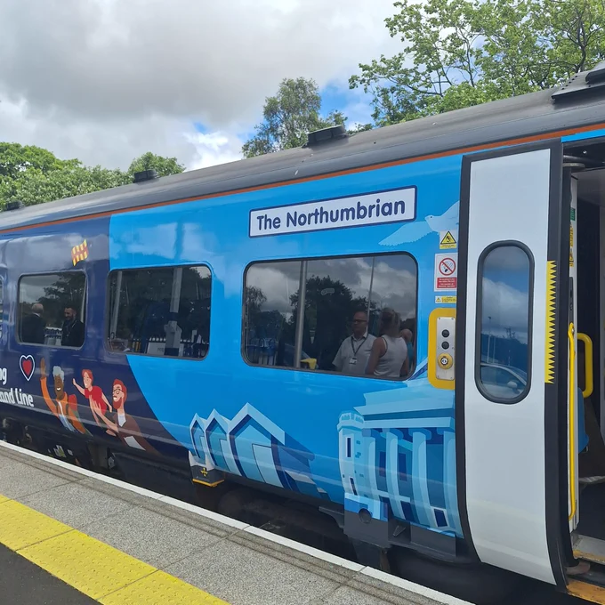 The side of the train with the name “The Northumbrian”.