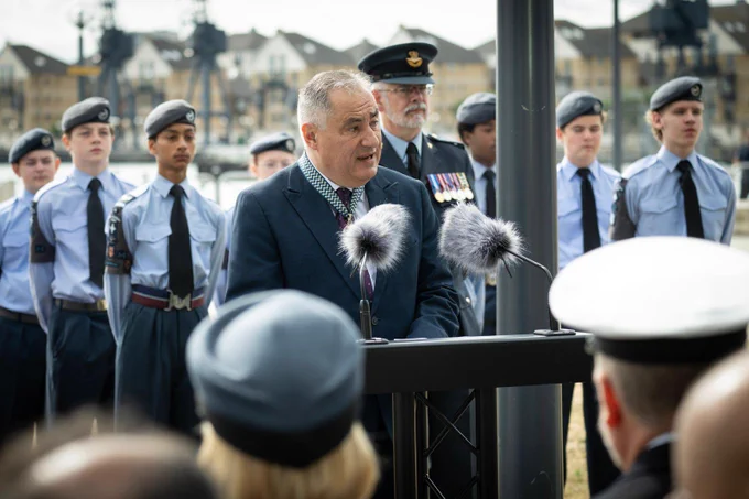 Man speaking at podium in front of cadets