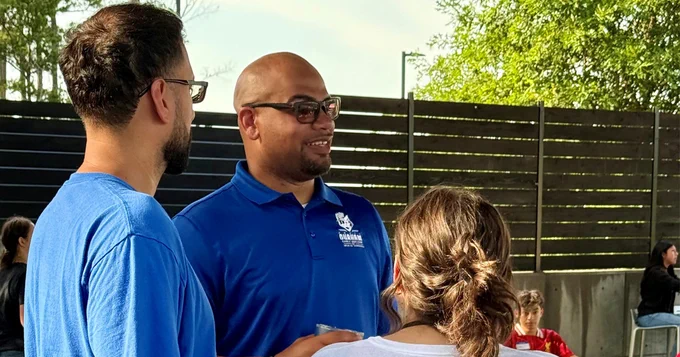 Three people discussing in an outdoor setting