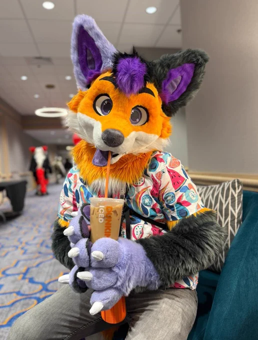 Photo of Scramble holding an iced coffee 
